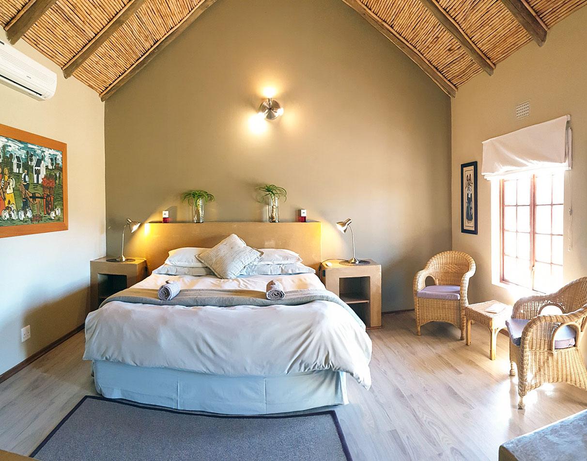 Interior of a spacious double bedroom at Thabile Lodge.