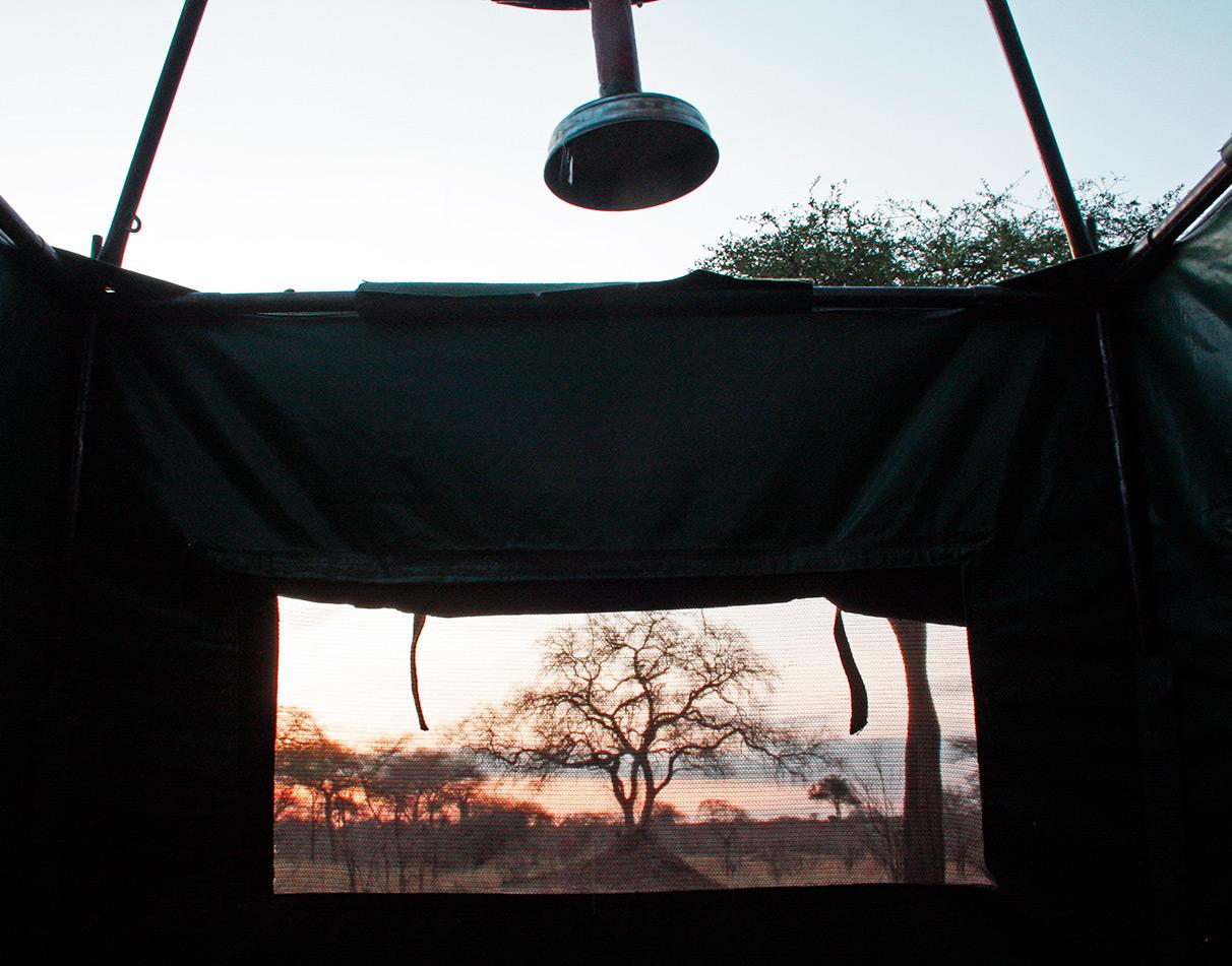 Outdoor bush shower at sunrise at a wild camping site.