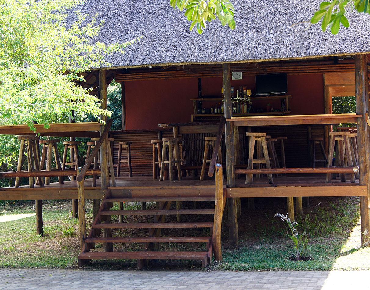 Thatched outdoor bar with wooden decking at Utshwayelo Lodge, Kosi Mouth.