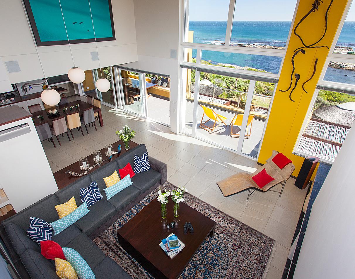 Bright and colourful common lounge at Crayfish Lodge with panoramic sea views, Hermanus.