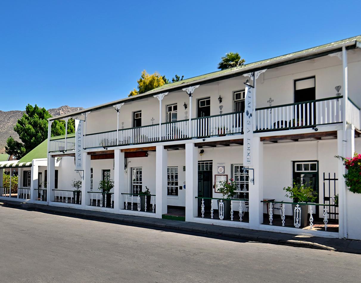 Historic double-storey white Victorian lodge with balconies in Montagu, Route 62.