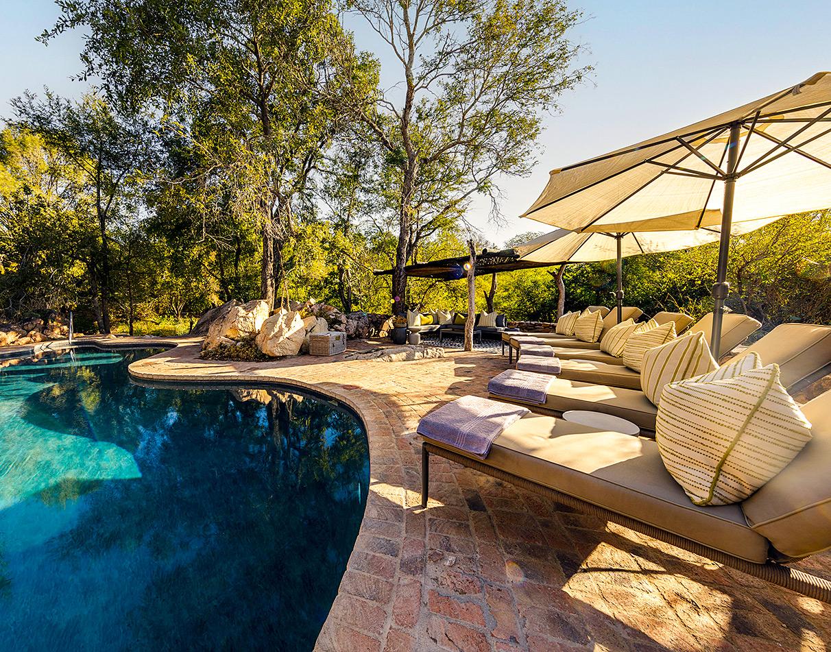 Pool deck with loungers at Sabi Sabi Little Bush Camp, South Africa.