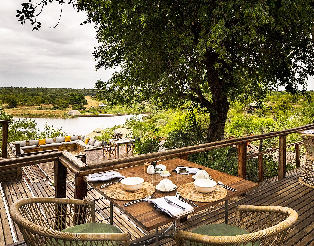 Simbavati Hilltop Lodge exterior tables and terrace with sweeping views.