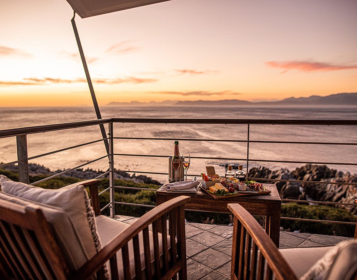 Sundowner drinks and cheese board on the balcony overlooking the ocean at Whalesong Beach Lodge.