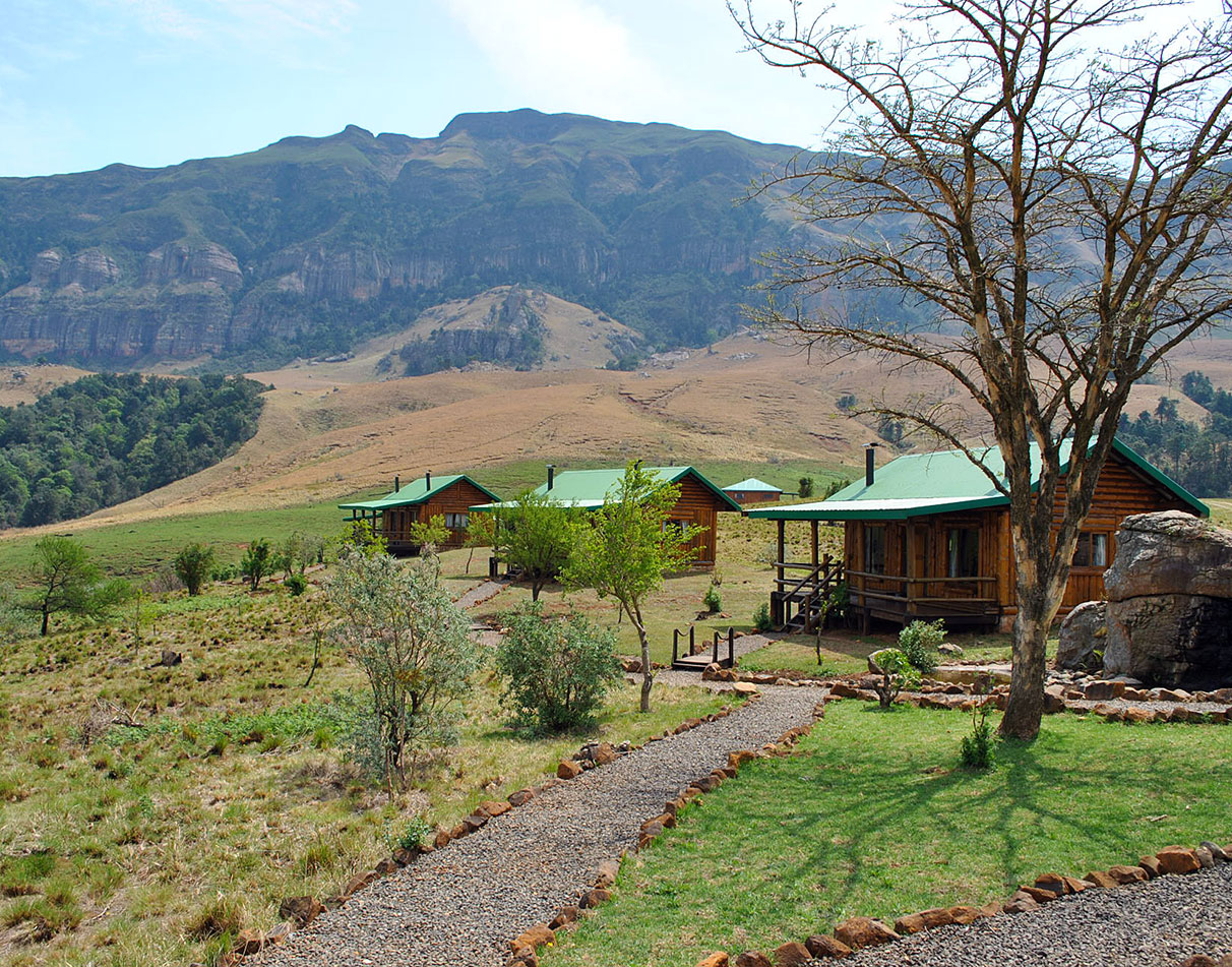 Greenfire Drakensberg Lodge cabins nestled in scenic landscape