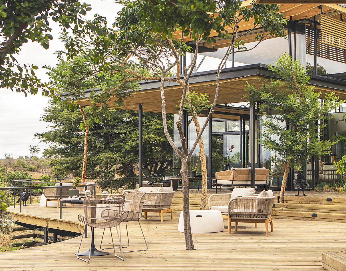 Lion Sands Ivory Lodge exterior terrace overlooking the bush.