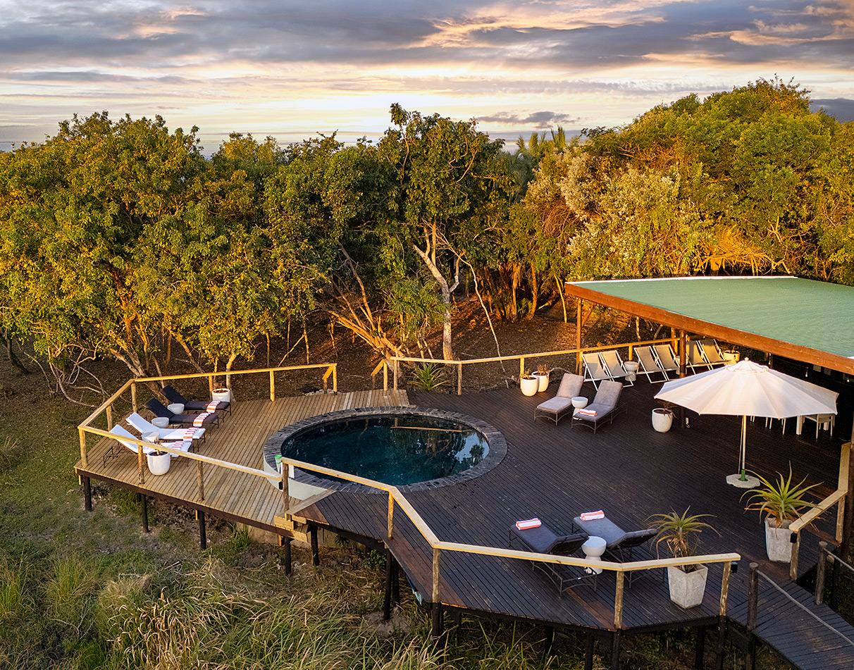 Pool deck at Makakatana Bay Lodge overlooking iSimangaliso wetlands.