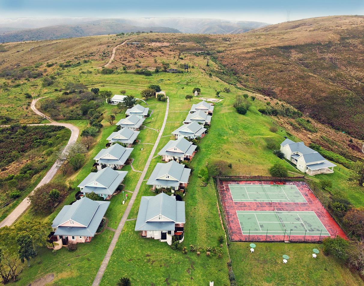 Aerial view of Zuurberg Mountain Village with cottage-style accommodation and tennis court.