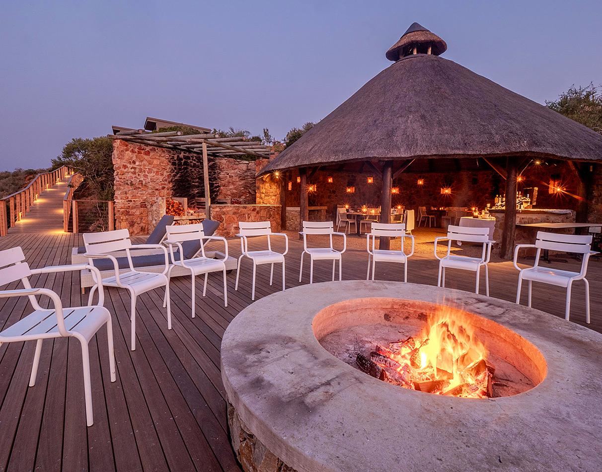 Fire pit lit at night on the terrace at Riverdene.