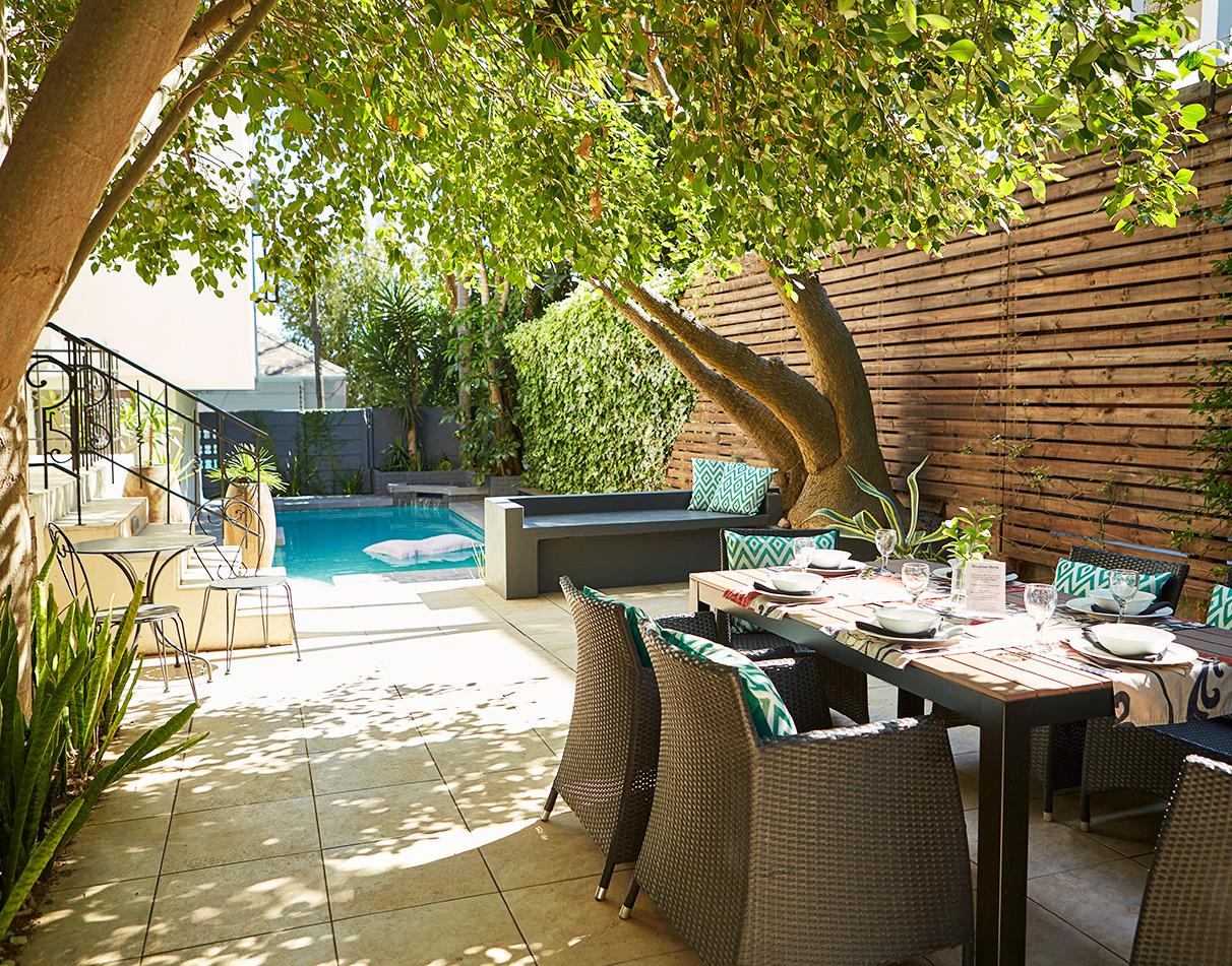 Lunch set up in the shade of a tree in the exterior patio of Bayflowers guesthouse, close by the pool.