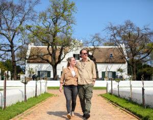 A couple enjoying a romantic walk through the vineyards in the Cape Winelands, South Africa.