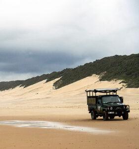 Safari vehcile driving on the beach at Isimangaliso Wetland Park as part of the game drive.
