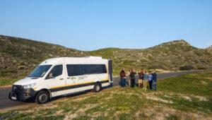 South Africa Experience tour van with group on scenic road trip.