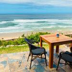 Mes Amis Guesthouse terrace table overlooking the Wilderness coastline.