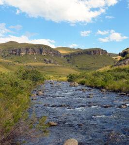 Mountain river flowing through the Drakensberg with bearded vulture country above.