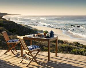 Romantic lunch set up on veranda at Lekkerwater beach lodge overlooking the ocean and beach.