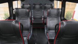 Mercedes Sprinter Van interior with black leather seats and red trim, ideal for South African safari tours.