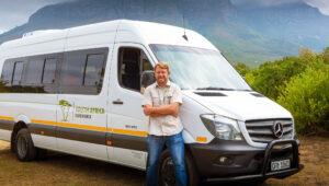 South AFrica Experience guide standing against our tour vehciles, the mercedes sprinter.
