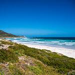 Waves crashing along the rugged coastline at Cape of Good Hope, Western Cape, South Africa.