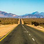 Long straight road stretching through the Klein Karoo towards Oudtshoorn.