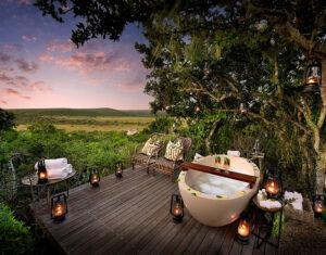 A romantic outdoor bathtub at sunset at Shamwari Sindile Lodge, South Africa.