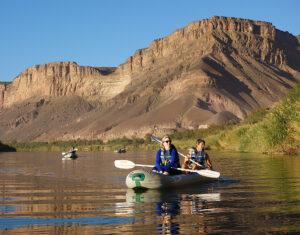 Two people kayaking on a lake in South Africa.