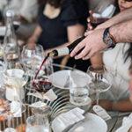 Wine being poured into glasses during a Stellenbosch wine tasting.