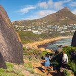 Small group of hikers on the Noordhoek coastal walk with ocean views.