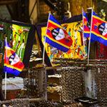 Colourful Swazi flags and textiles at a market.