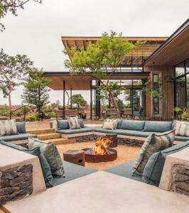 Lion Sands Ivory Lodge fire deck and outdoor seating area overlooking the bush.