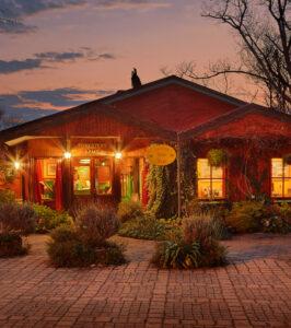 Foresters Arms Country Hotel exterior illuminated at dusk with warm lighting.
