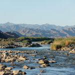 Richtersveld National Park rocks in the river and mountain background landscape.