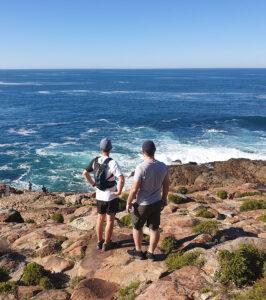 Two guest admiring the ocean while on a coastal hike along the Garden Route.