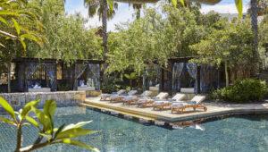 Poolside loungers surrounded by lush greenery at One&Only Cape Town.