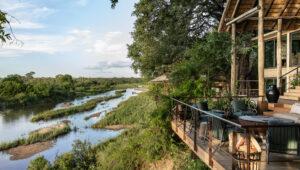 A wooden terrace overlooking the Sand River at Singita Ebony Lodge.