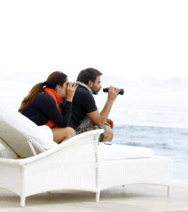 Couple whale watching from a balcony at Birkenhead House, Hermanus