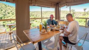 Couple having breakfast, AfriCamps Addo, South Africa.