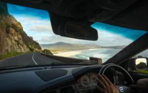 A person drives along Chapman's Peak a popular road on self-drive tours in South Africa.