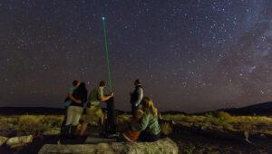 Guests stargazing with a telescope under the Milky Way at Sanbona Wildlife Reserve.
