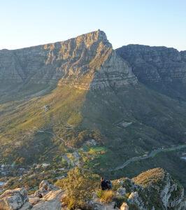 Sunlit cliffs and ridges of Table Mountain seen from above, Cape Town, South Africa.