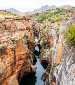 Visitors crossing a footbridge over the rock pools at Bourke's Luck Potholes, Blyde River Canyon.