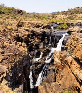 A waterfall flowing down rocks along the panorama route.