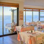Dining area with ocean views at Fairlight Beach House.
