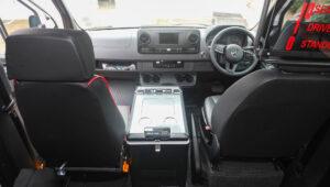 Interior view of a safari vehicle, showing seats, dashboard, and Engel cooler.