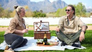 A couple enjoying a romantic picnic in the Cape Winelands on one of our tailor made tours south africa.