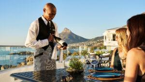 A waiter serving guests with ocean views at 12 Apostles Hotel, Lion's Head, Cape Town.