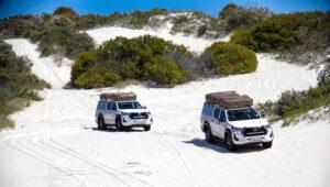 A convoy of 4x4 vehicles on the Atlantis Dunes on a guided self-drive.
