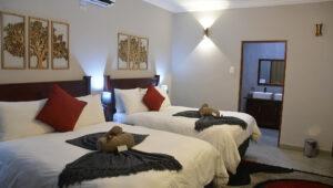 Twin beds in a hotel room, ideal for guided hikes in South Africa.