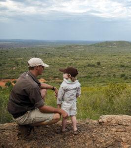 A Ranger with a child standing on a viewpoint in the Madikwe Game Reserve.