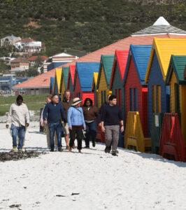 Small group tour at the colourful beach huts of Muizenberg Beach, South Africa.